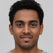 Latino young-adult male with short black hair and brown eyes.